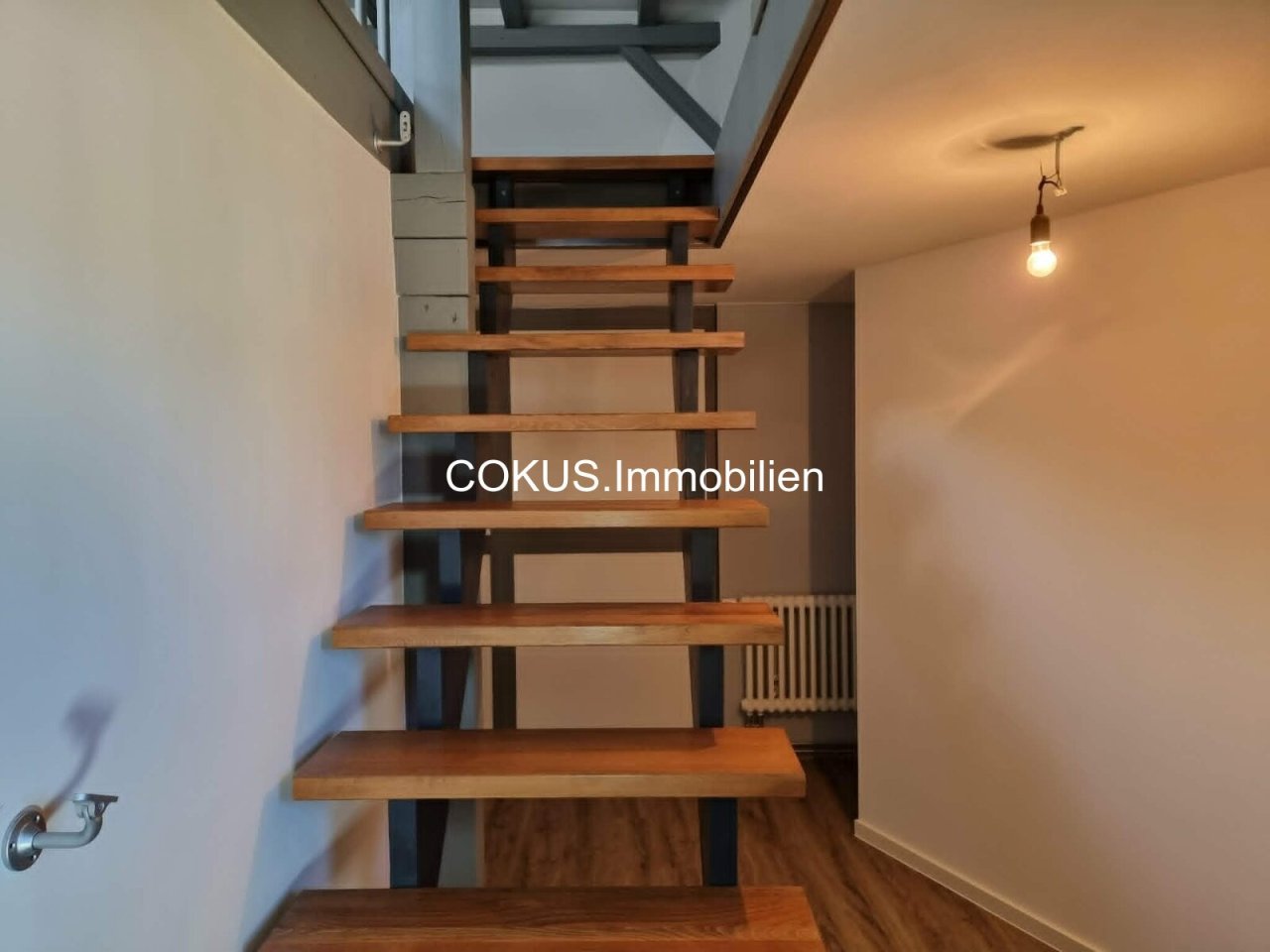 Offene Holztreppe hinauf in die Maisonette-Ebene Offene Holztreppe hinauf in die Maisonette-Ebene
